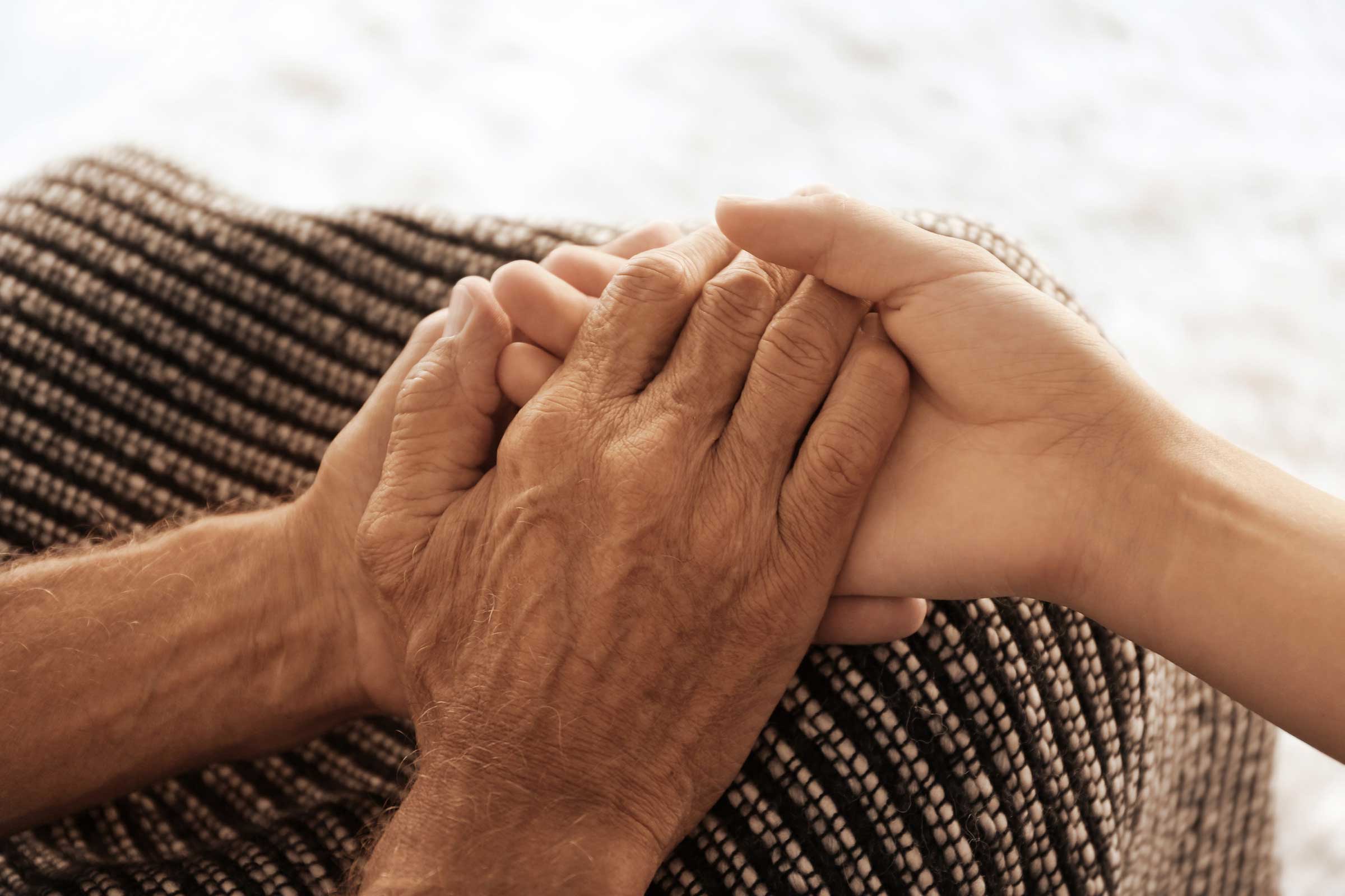 Person holding another person's hands
