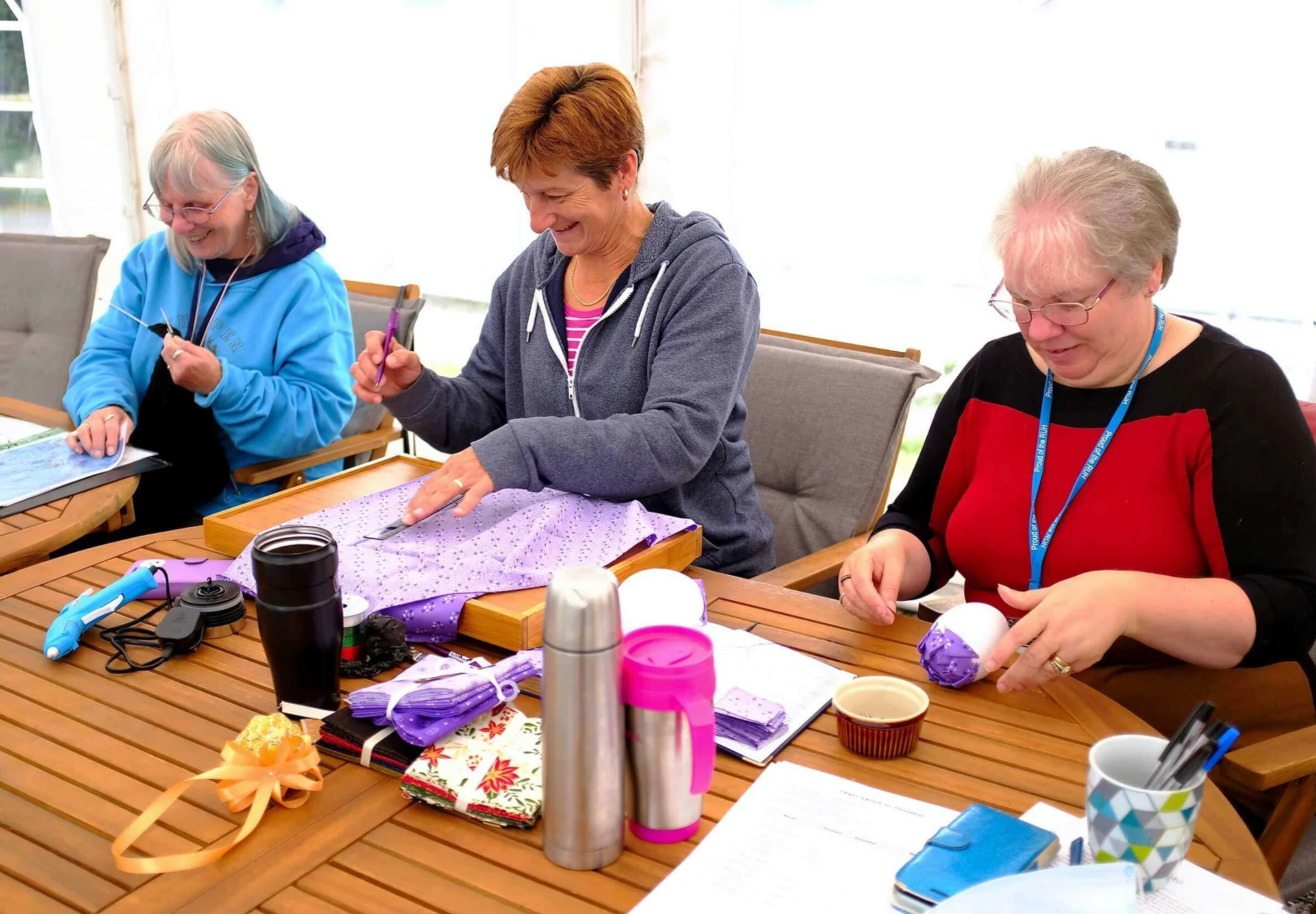 Women sat at a table doing crafts