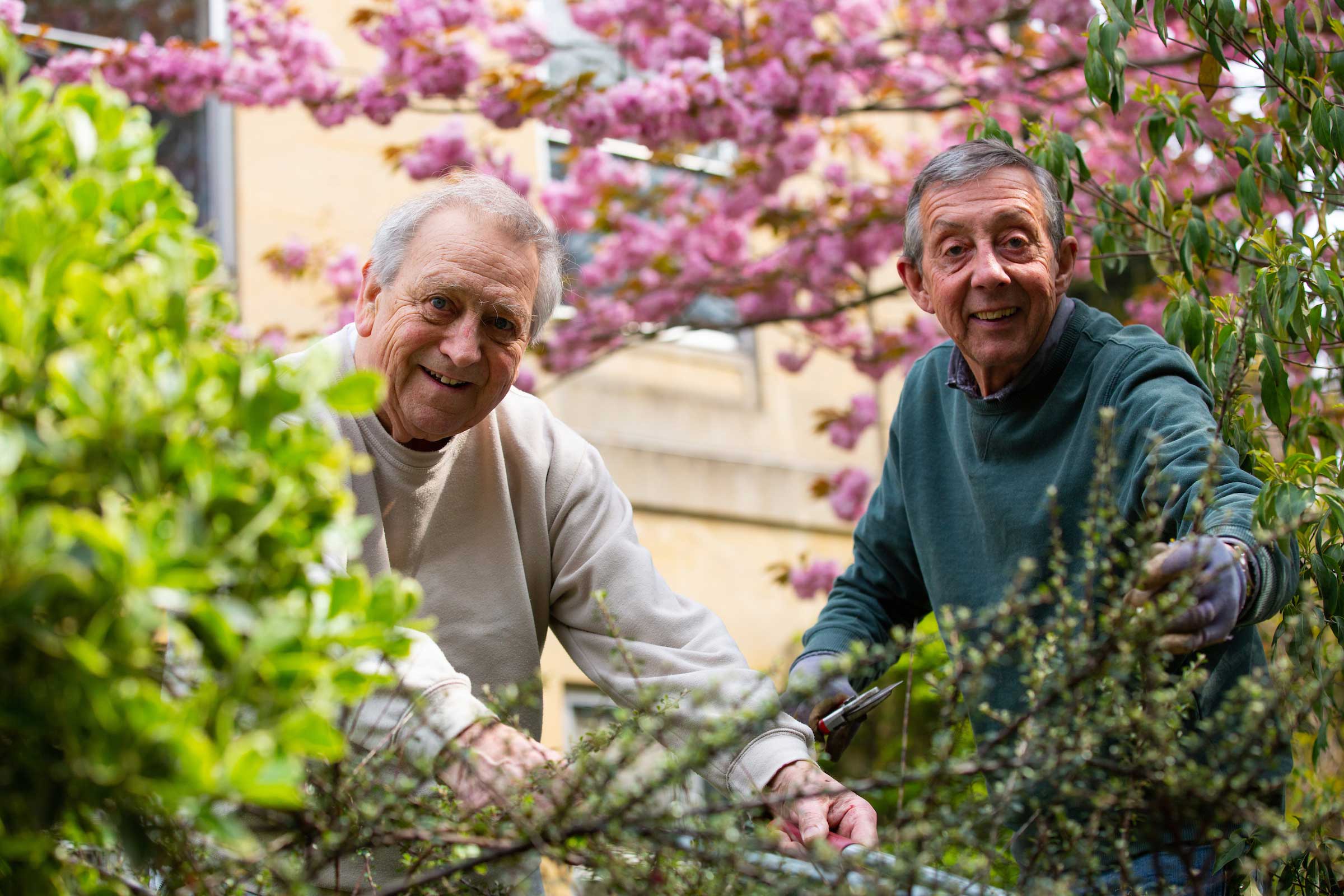 Two men volunteering in the garden at The Carers' Centre