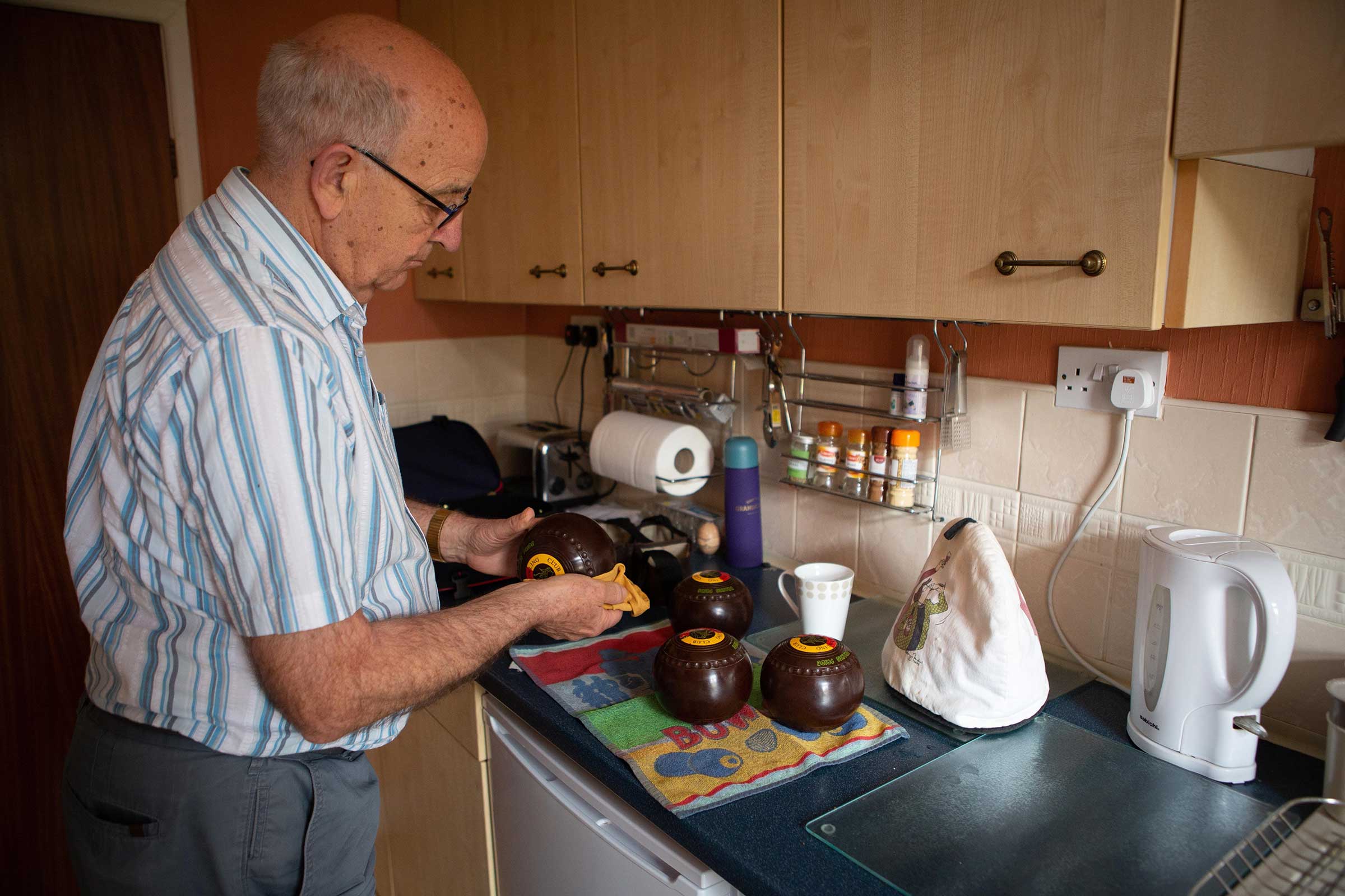 Man in the kitchen cleaning his bowls balls