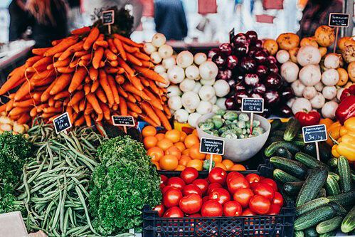 Veg stall with carrotts, onions, tomatoes, etc