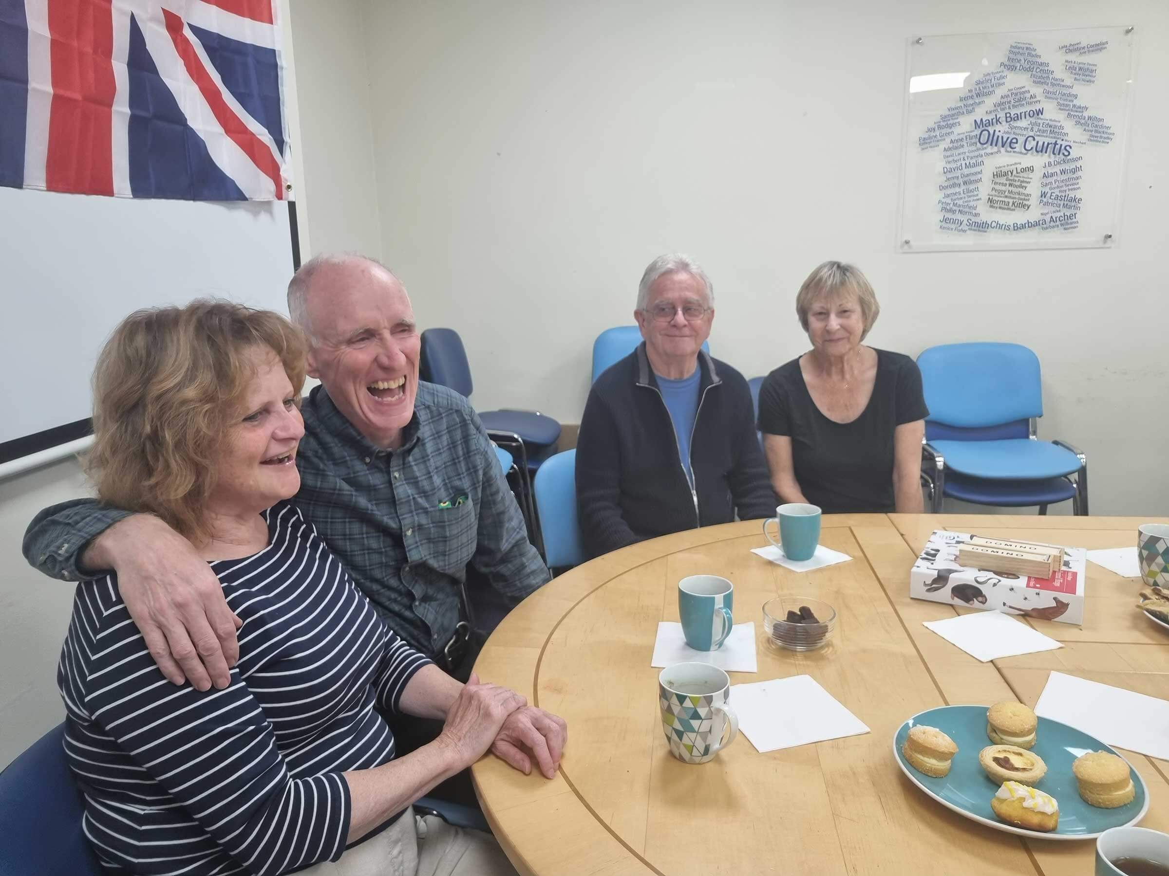 People sat around a table at a dementia cafe 