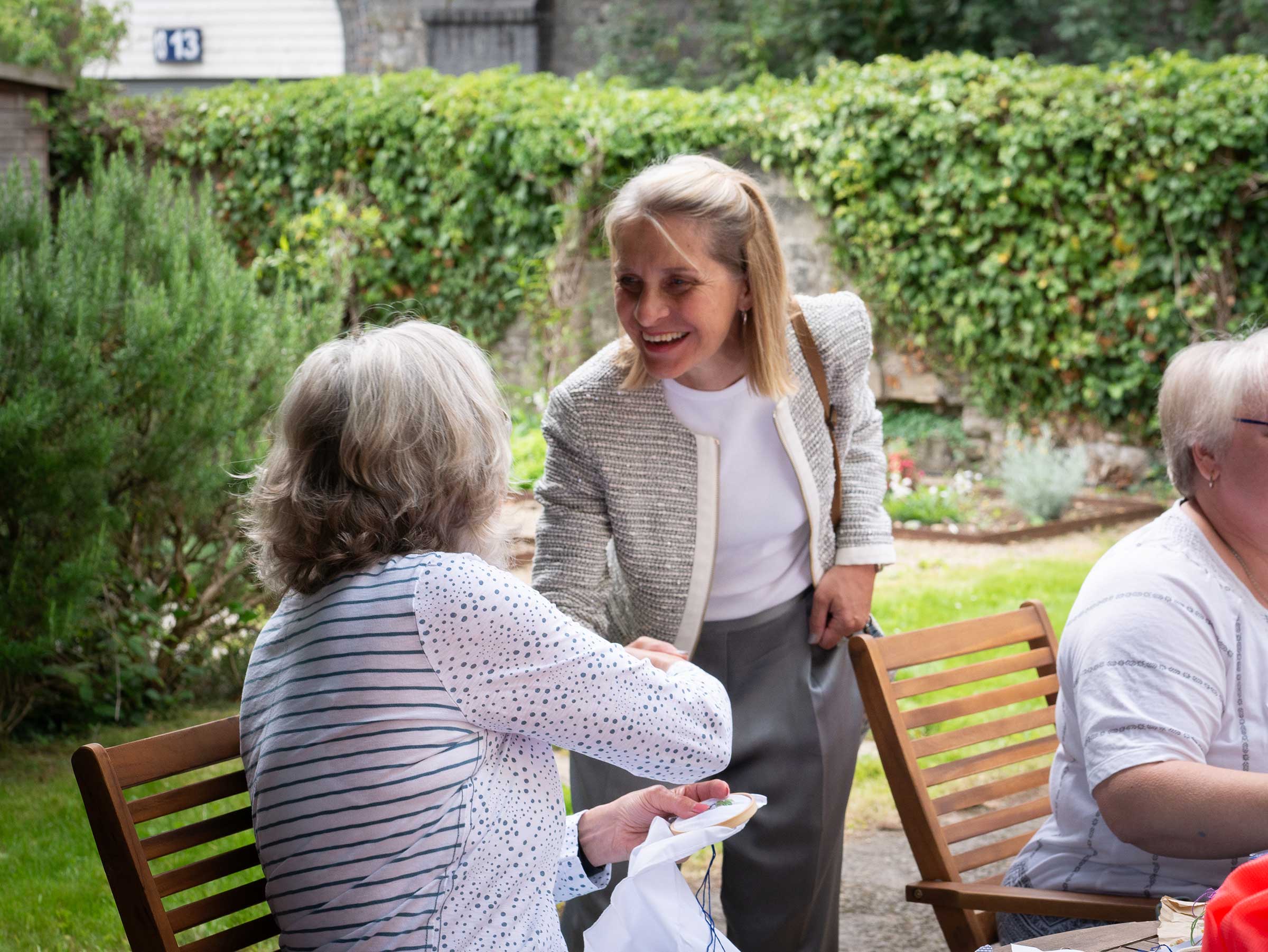 Wera Hobhouse MP shaking hands with a carer