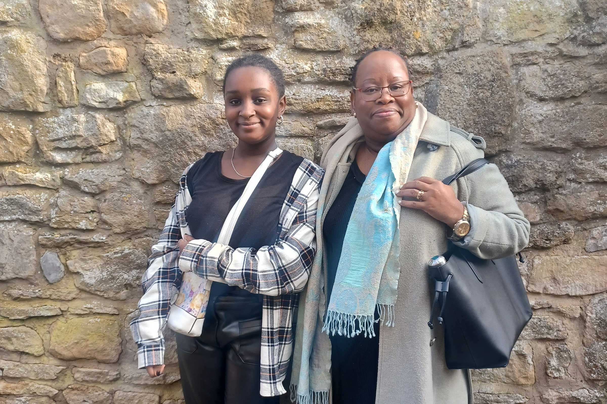 Black girl with a black woman smiling at the camera