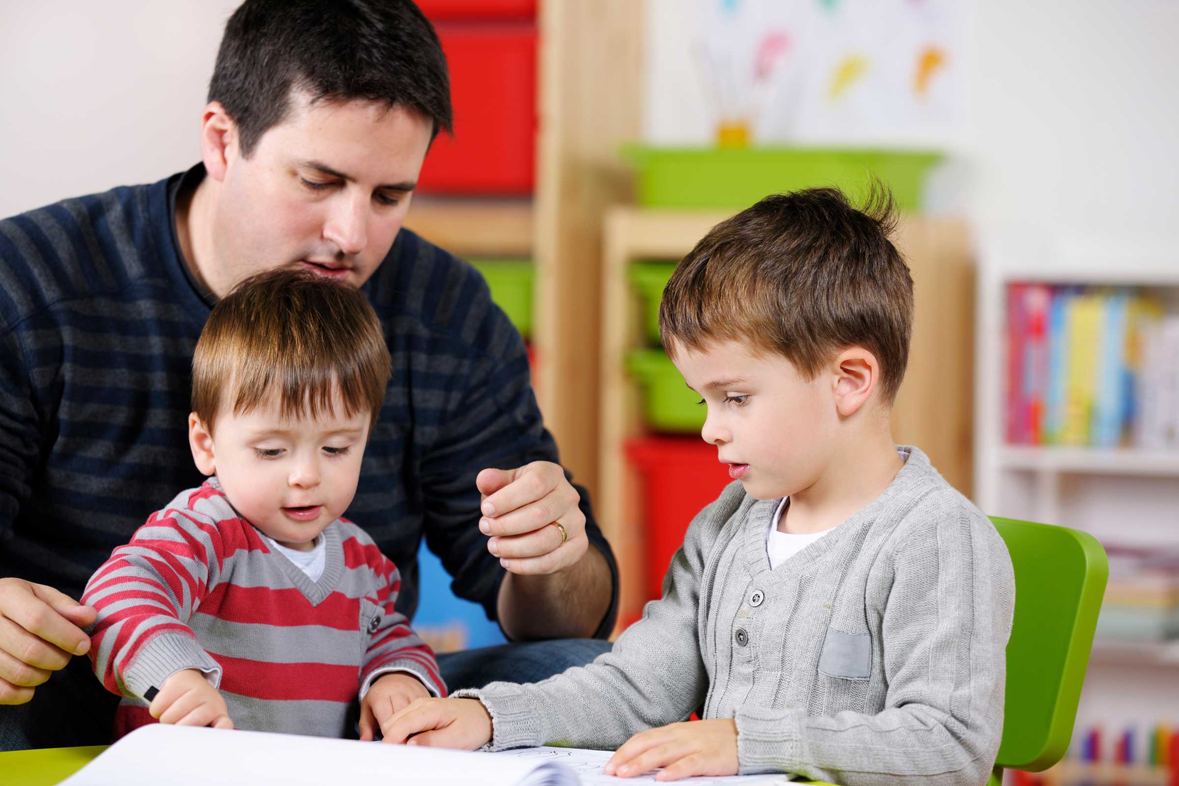 Man with two children playing