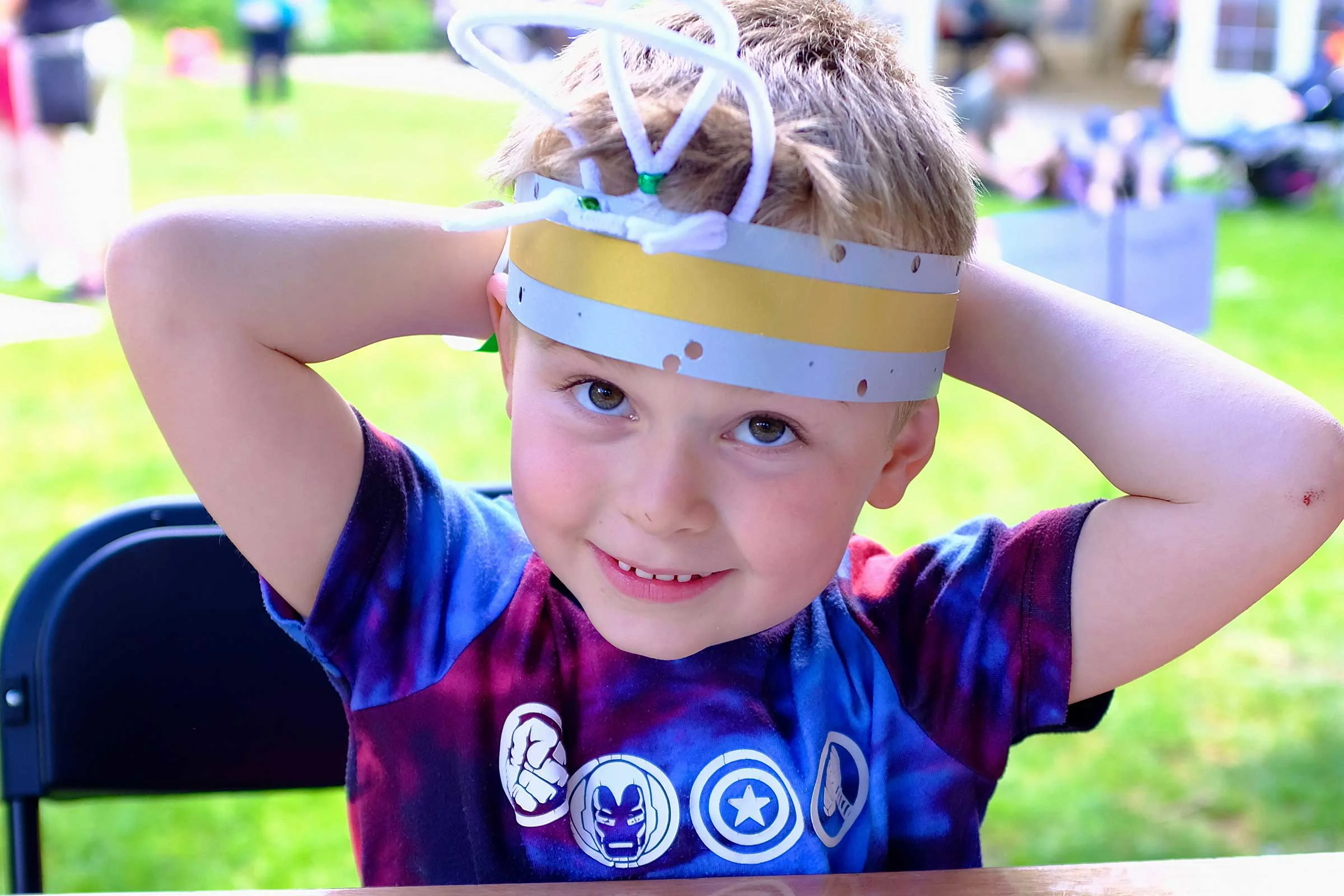 A young carer with a hand made party hat on