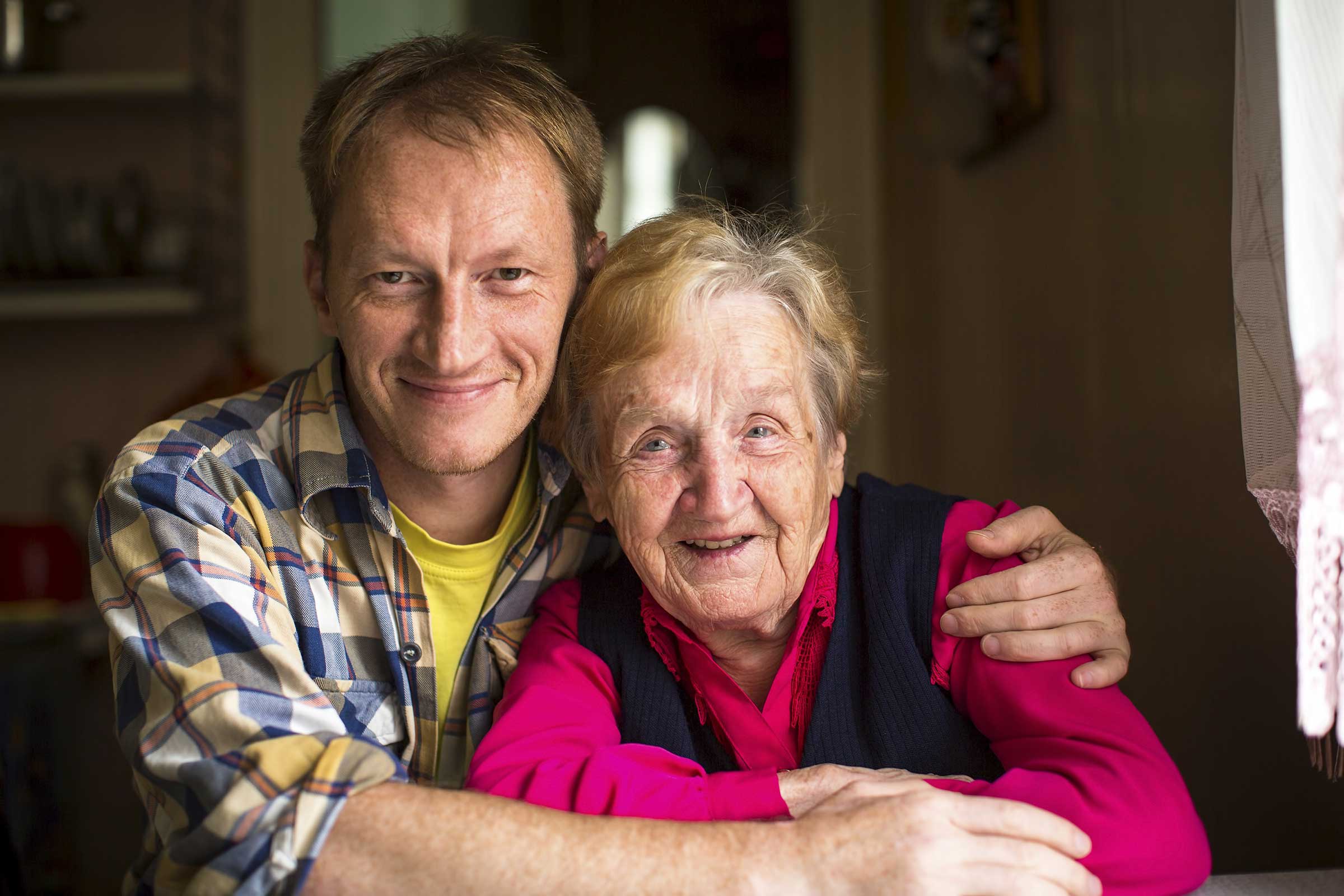 Man hugging a lady looking at the camera