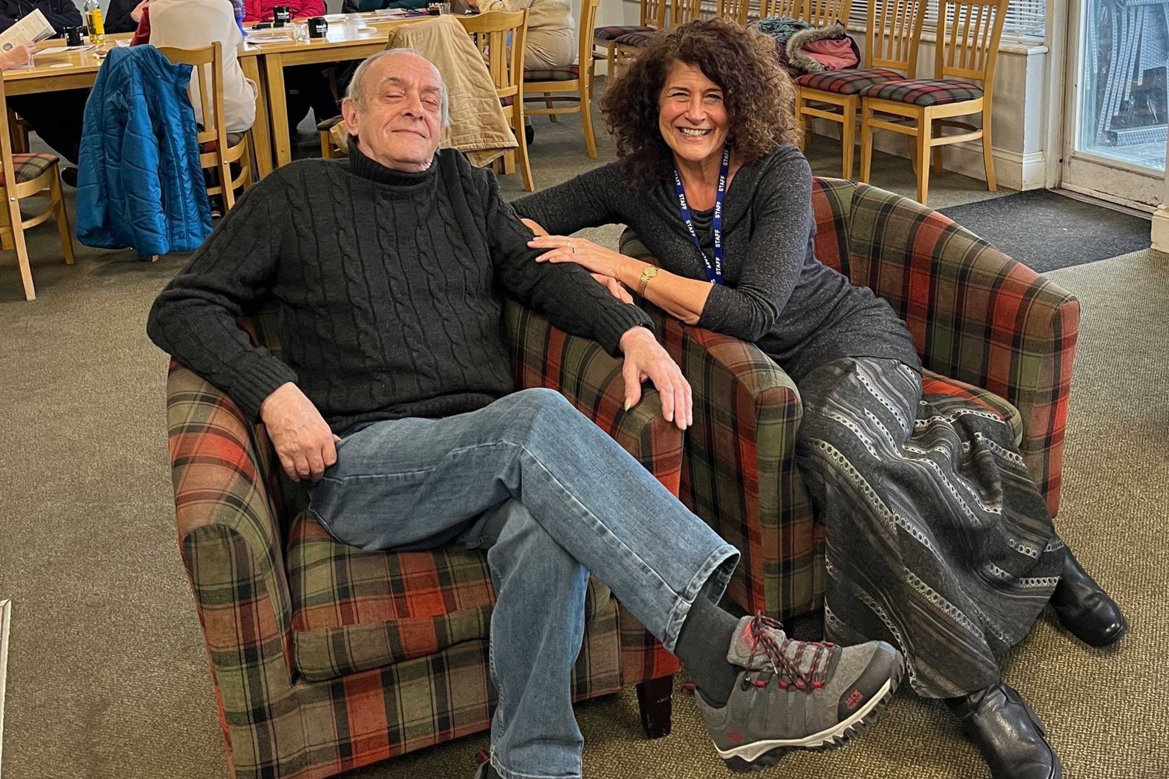 Steve and Carmen sat in chairs smiling at the camera