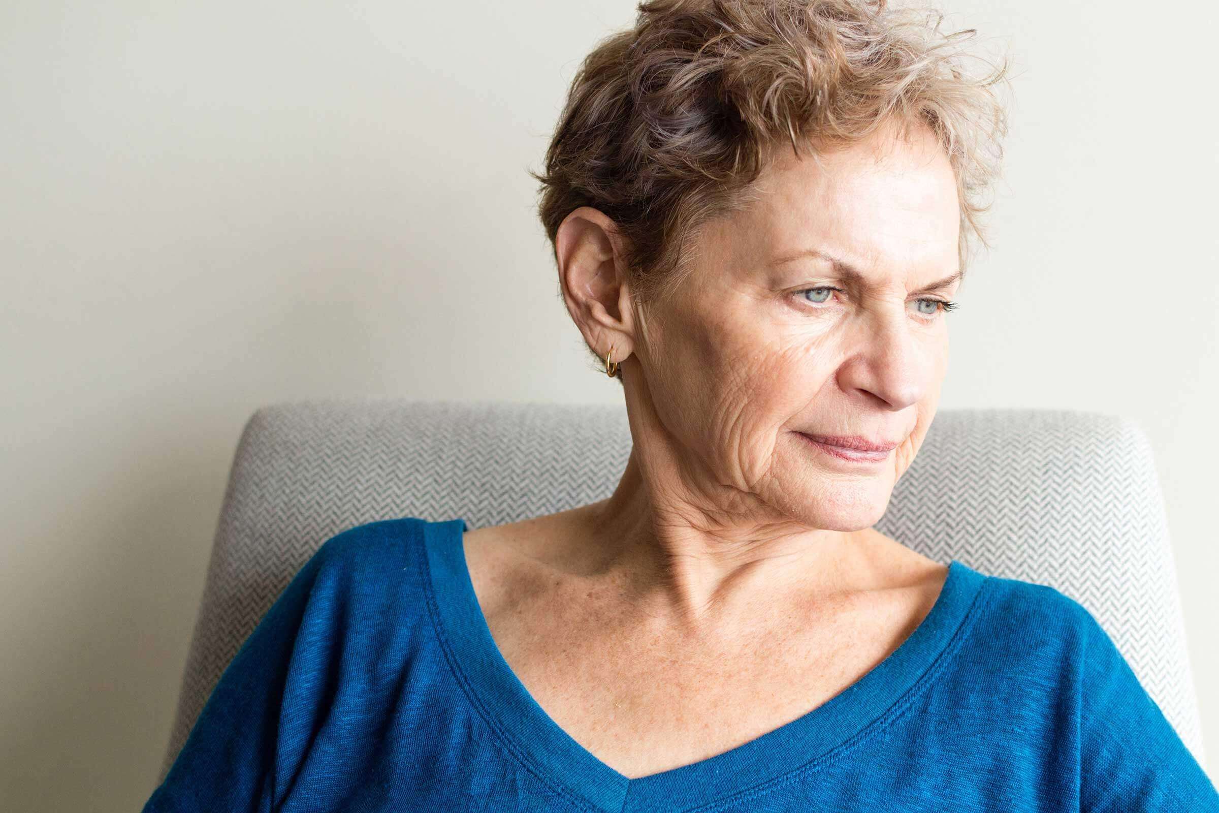 Woman sat down looking away from the camera
