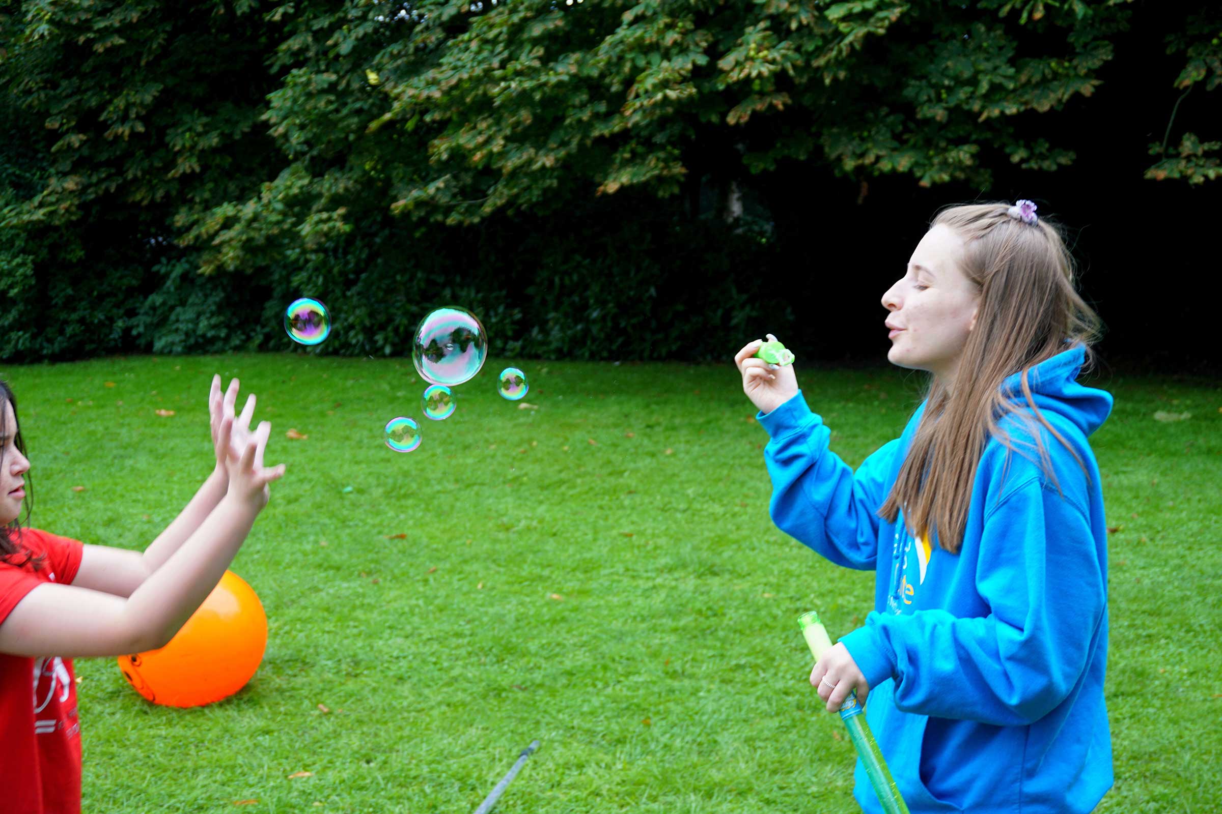 Volunteer blowing bubbles
