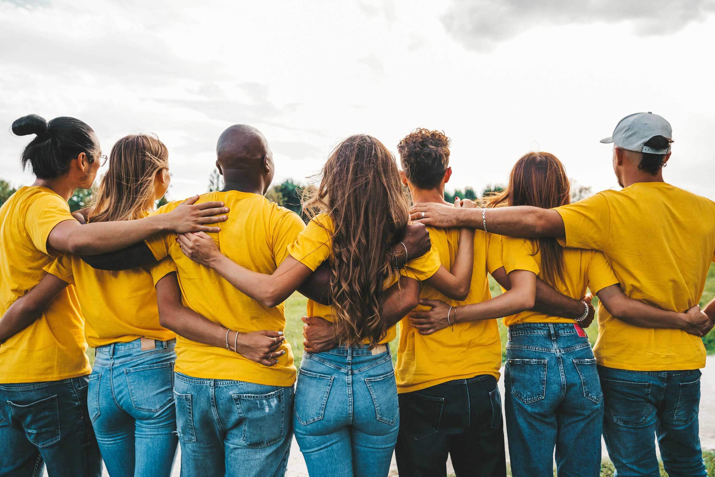 Group of people from behind hugging