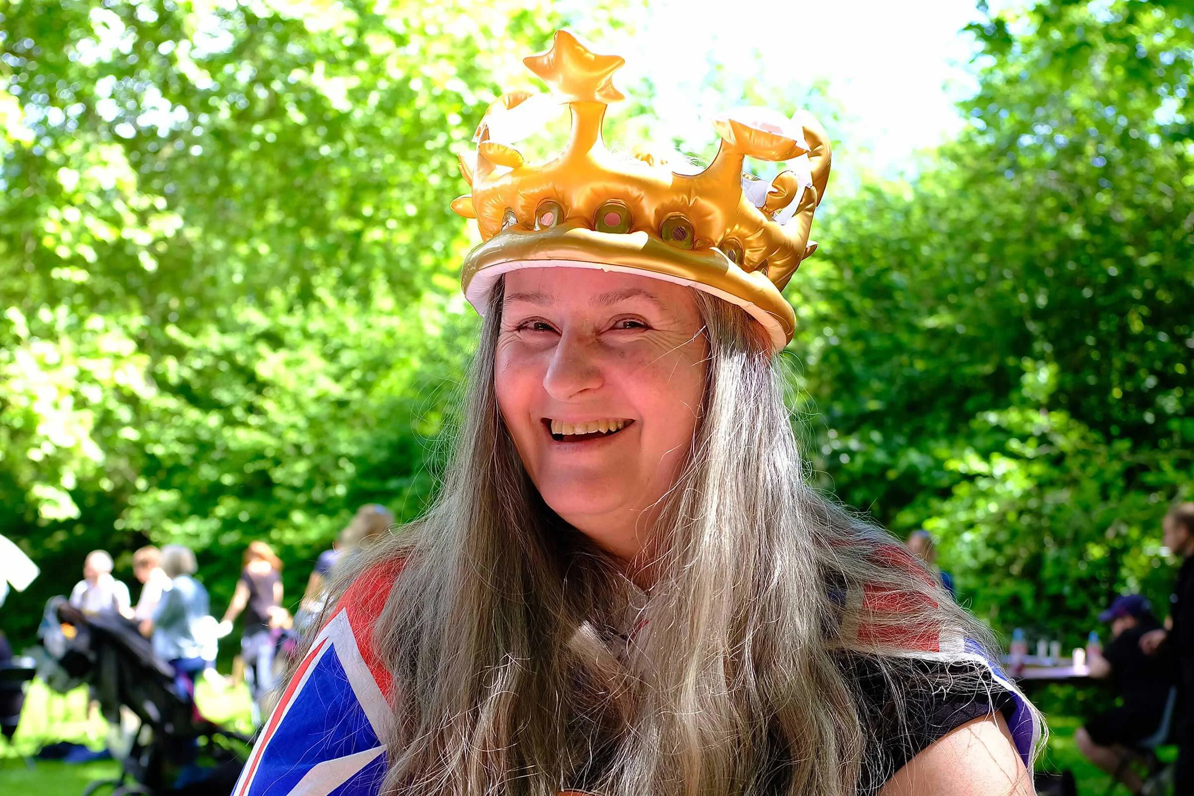 Lady with a blow up crown on smiling at the camera