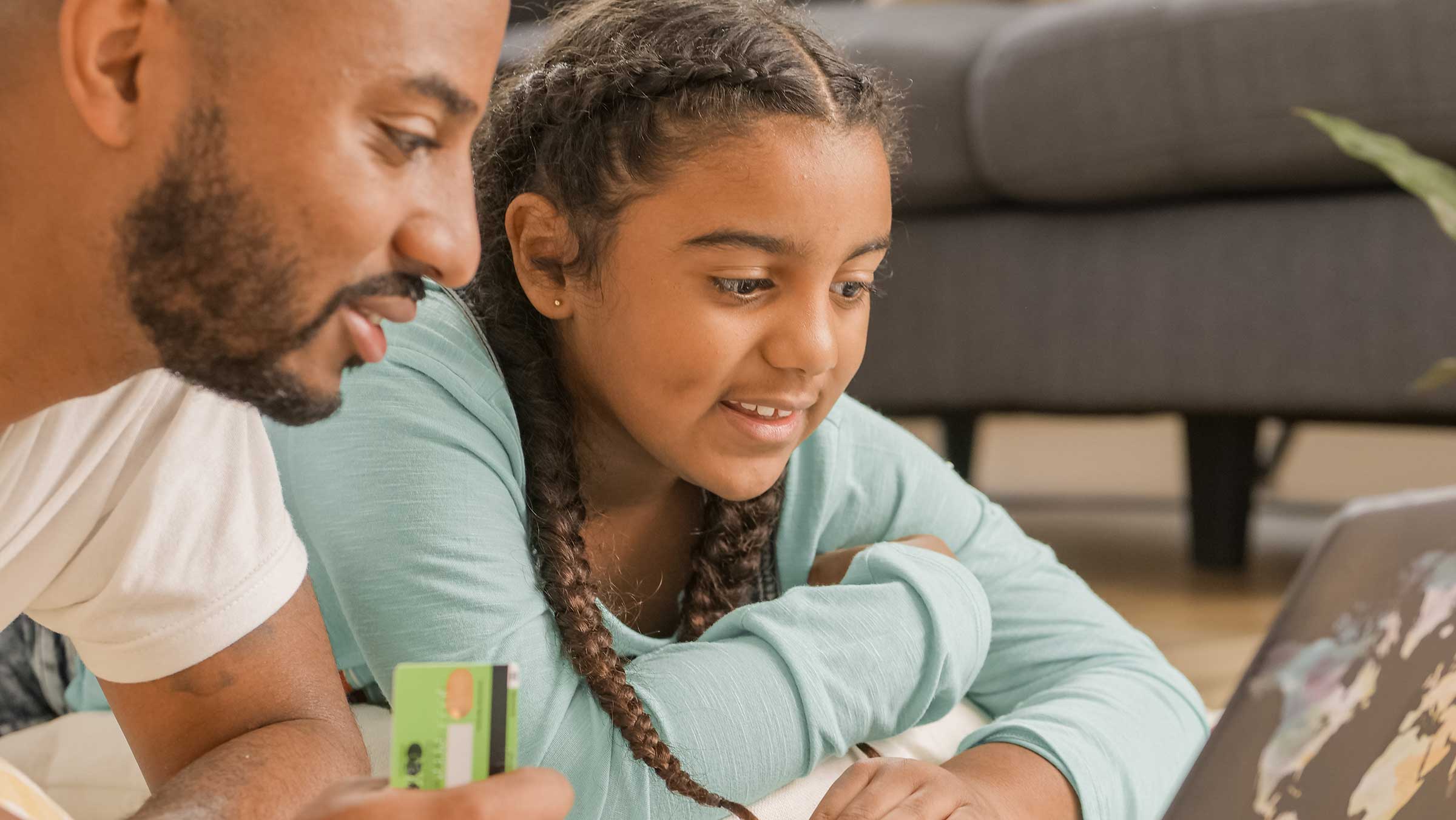 Young girl and man looking at a laptop