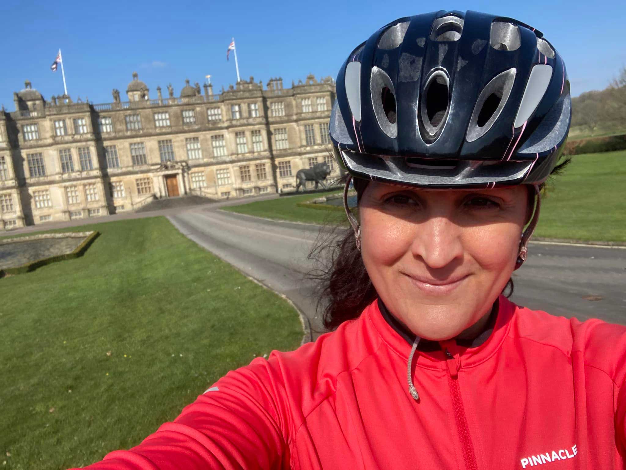 Woman in cycling gear with a helmet on taking a selfie
