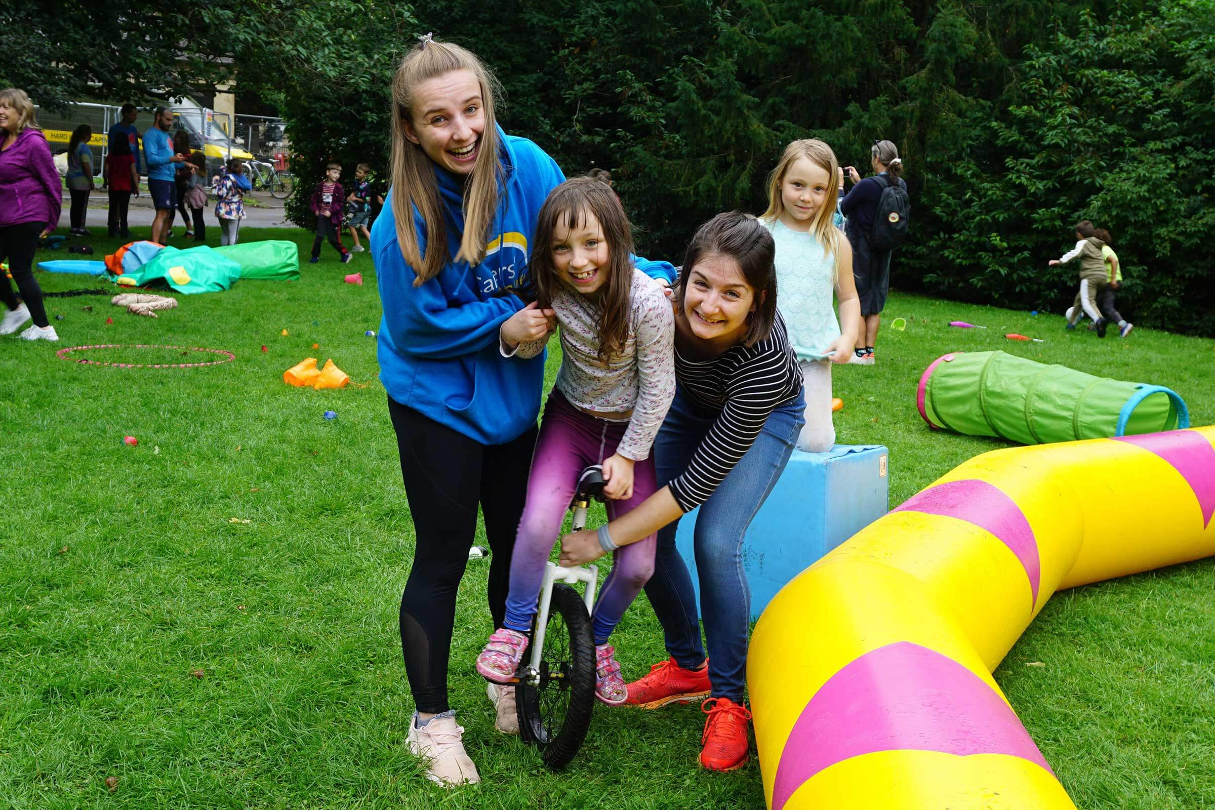 Lady with young carers and Carers' Centre staff