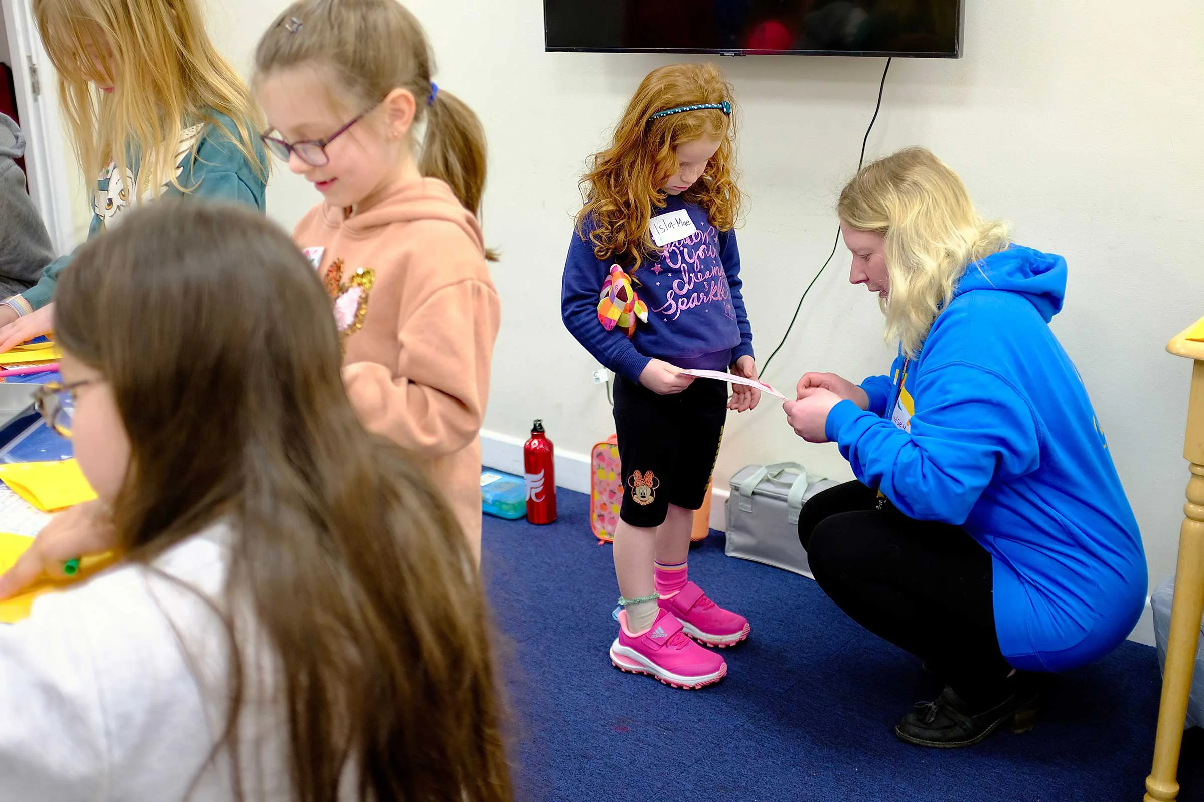 Lindsey speaking with a little girl about her drawing